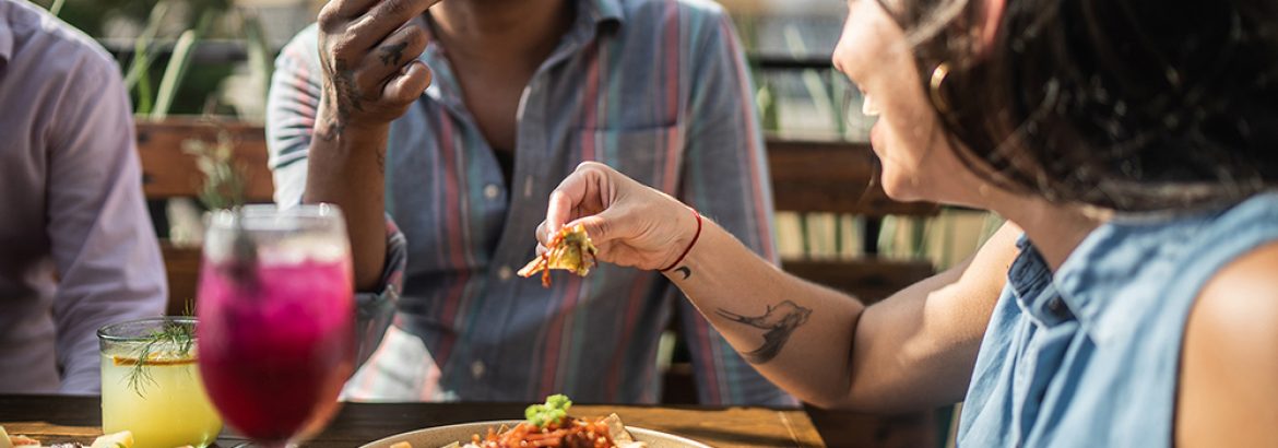 Friends eating guacamole at a restaurant